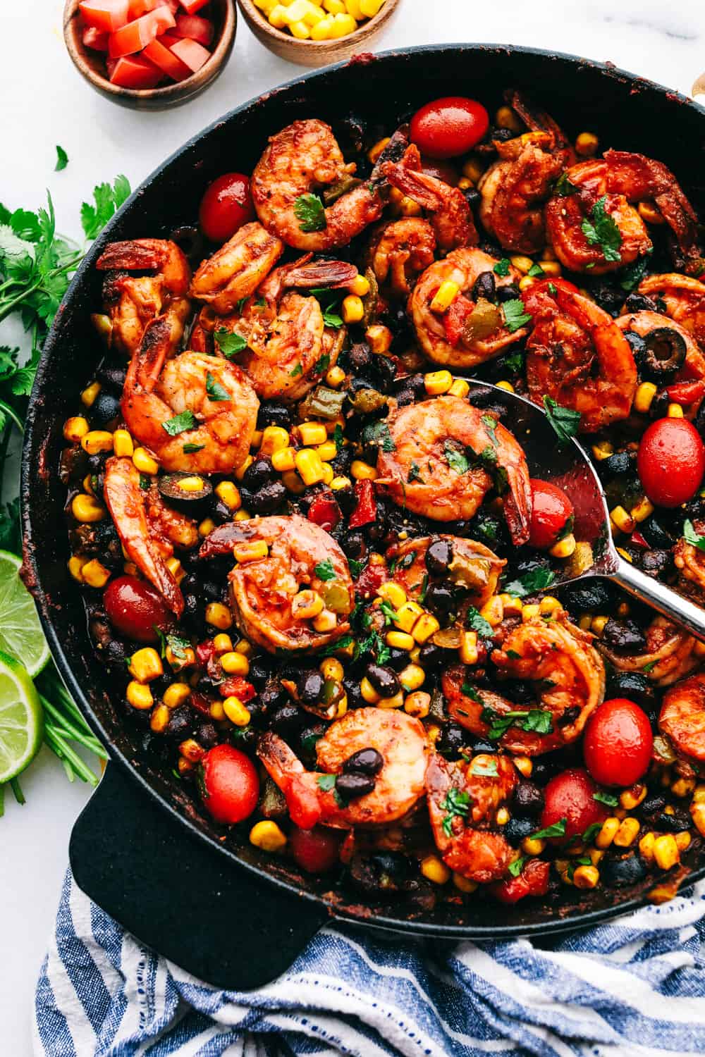 Mexican shrimp skillet in a skillet with a spoon.