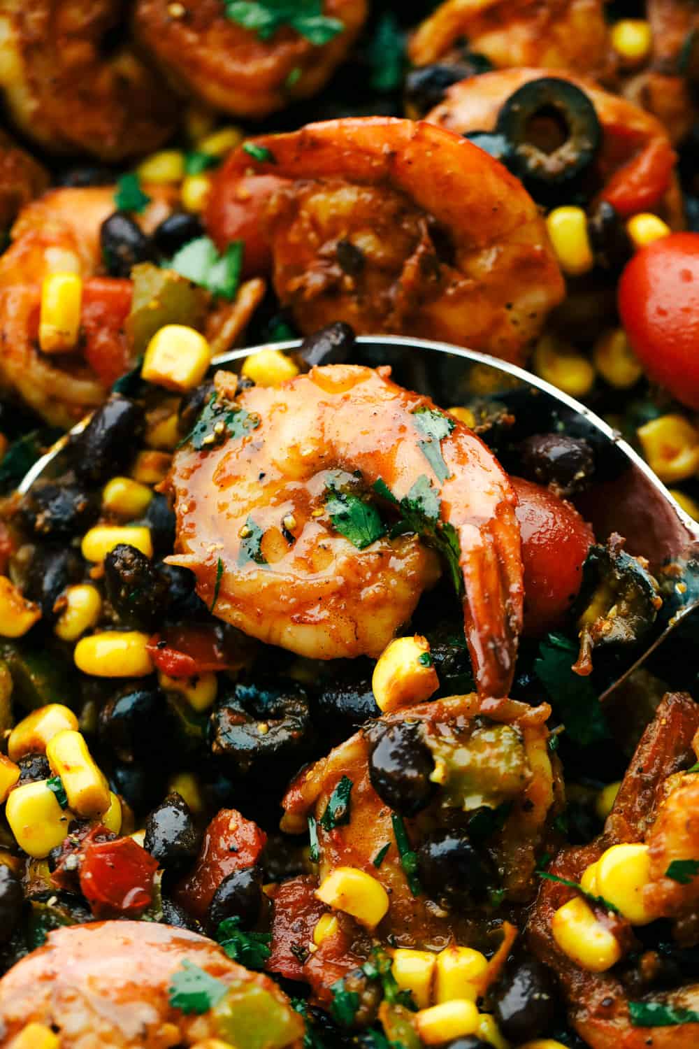 Mexican Shrimp Skillet with an up close photo with a spoon and shrimp on it. 