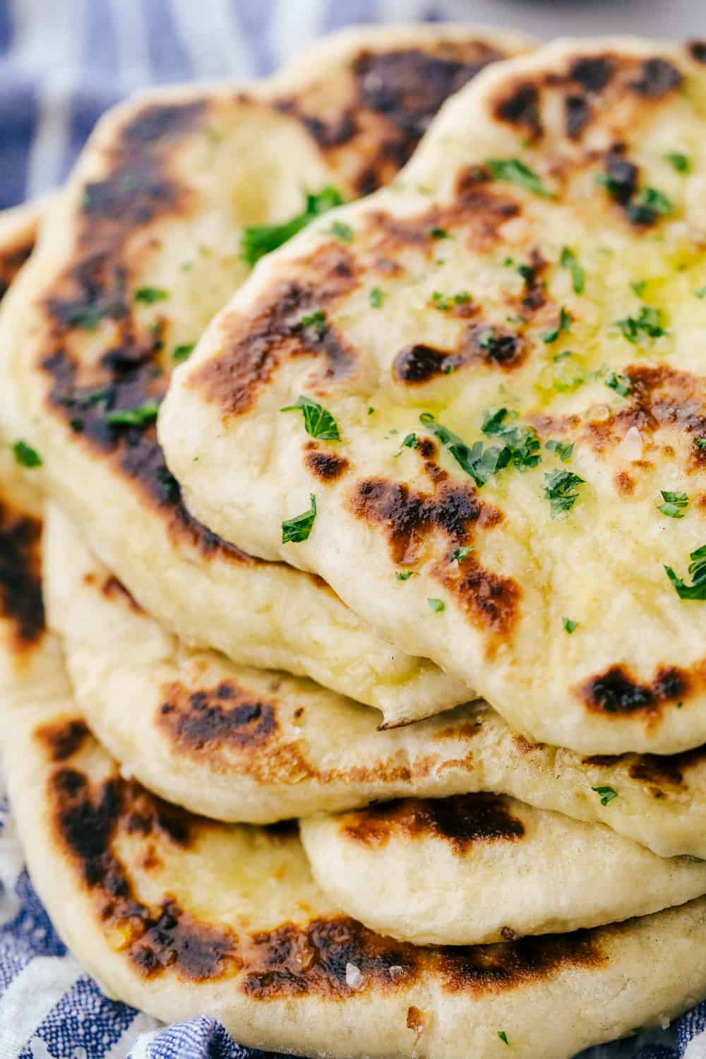 Naan bread stacked on top of each other. 