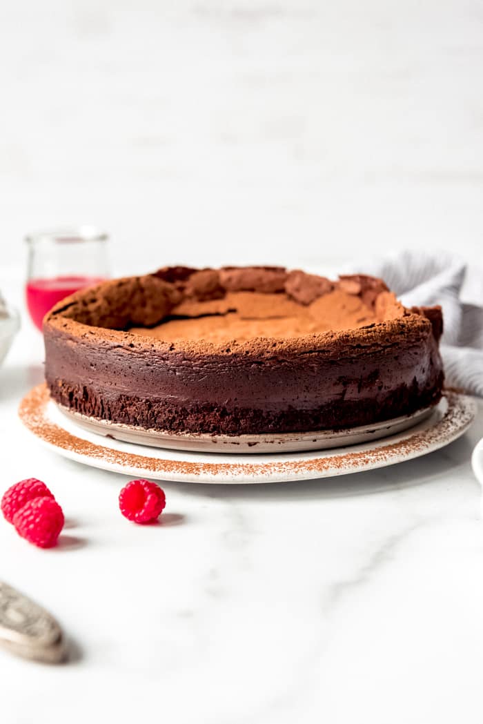 An image of a flourless chocolate torte dusted with cocoa powder.