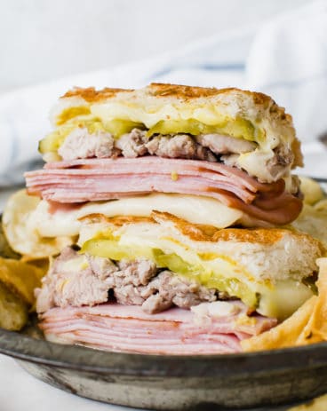 cuban sandwich stacked on top of each other on metal plate