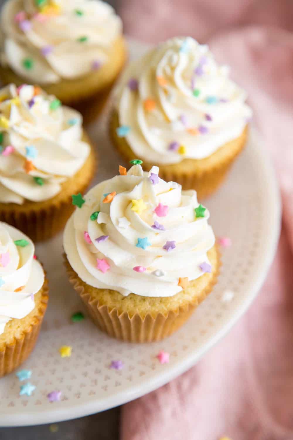 Vanilla cupcakes on a cake stand