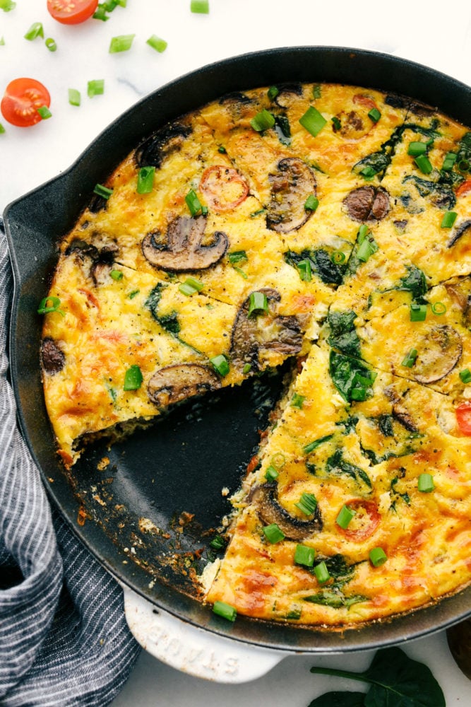 Frittata de desa yuno cocinada en una sartén con una rodaja de frittata que falta. 