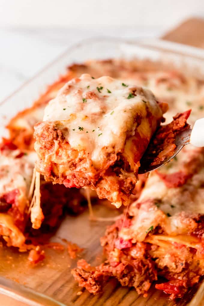 An image of a serving of lasagna roll ups being lifted from the pan with a spatula.