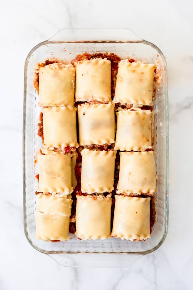 An image of rolled up lasagna noodles in a baking dish.
