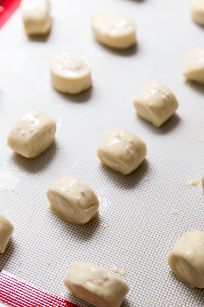 Unbaked pretzel bites on a baking tray