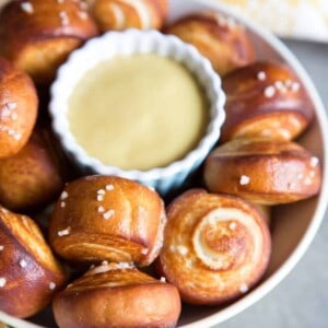 Pretzel bites in a bowl with a cup of mustard
