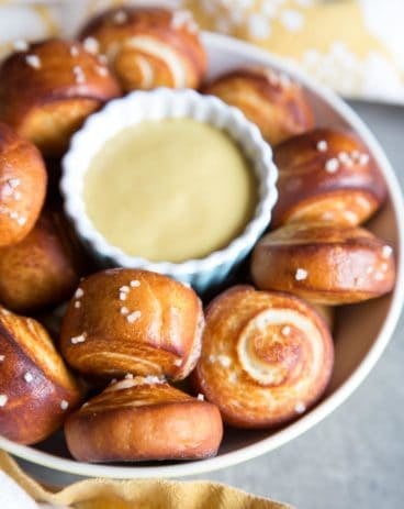 Pretzel bites in a bowl with a cup of mustard