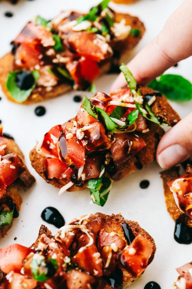 Bruschetta presented on a white plate.