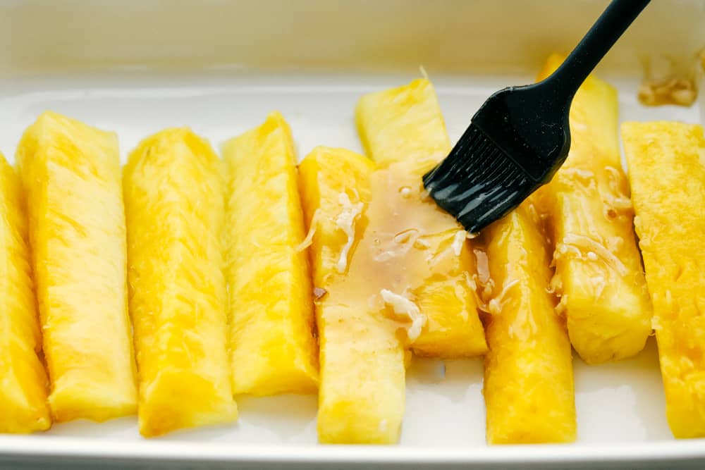 Pineapple sliced in quarters brushed with the coconut lime juice. 