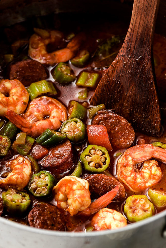 A pot of authentic Gumbo made up of okra, tomatoes, shrimp, and sausage.
