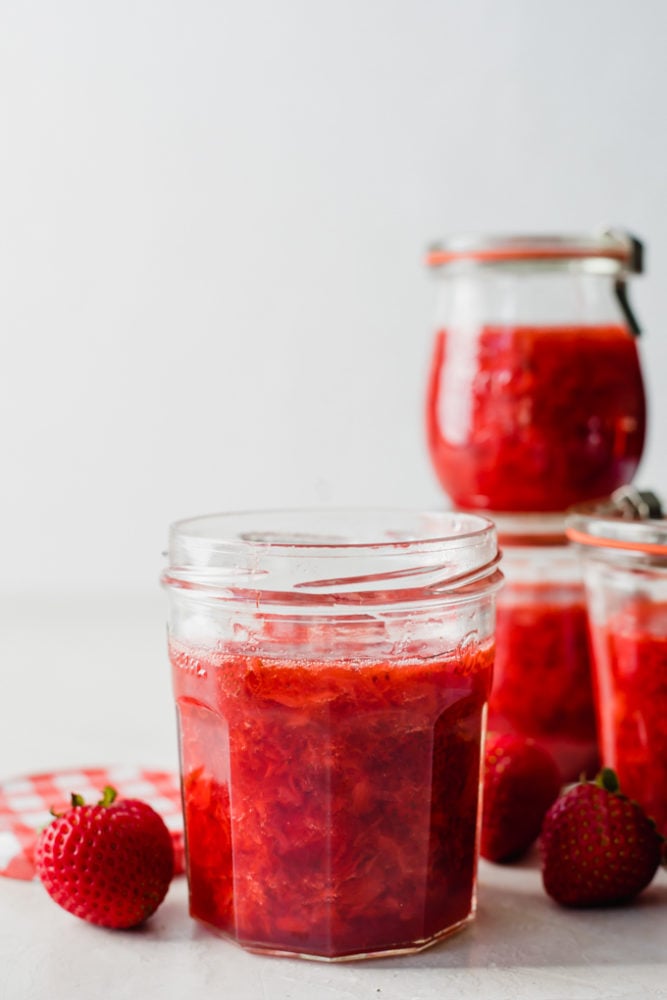 Homemade strawberry jam in a glass jar. 