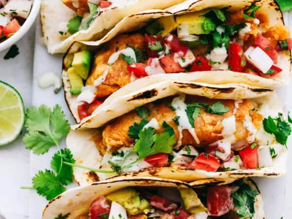 Baja fish tacos lined in a row.