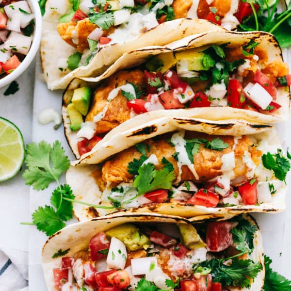 Baja fish tacos lined in a row.