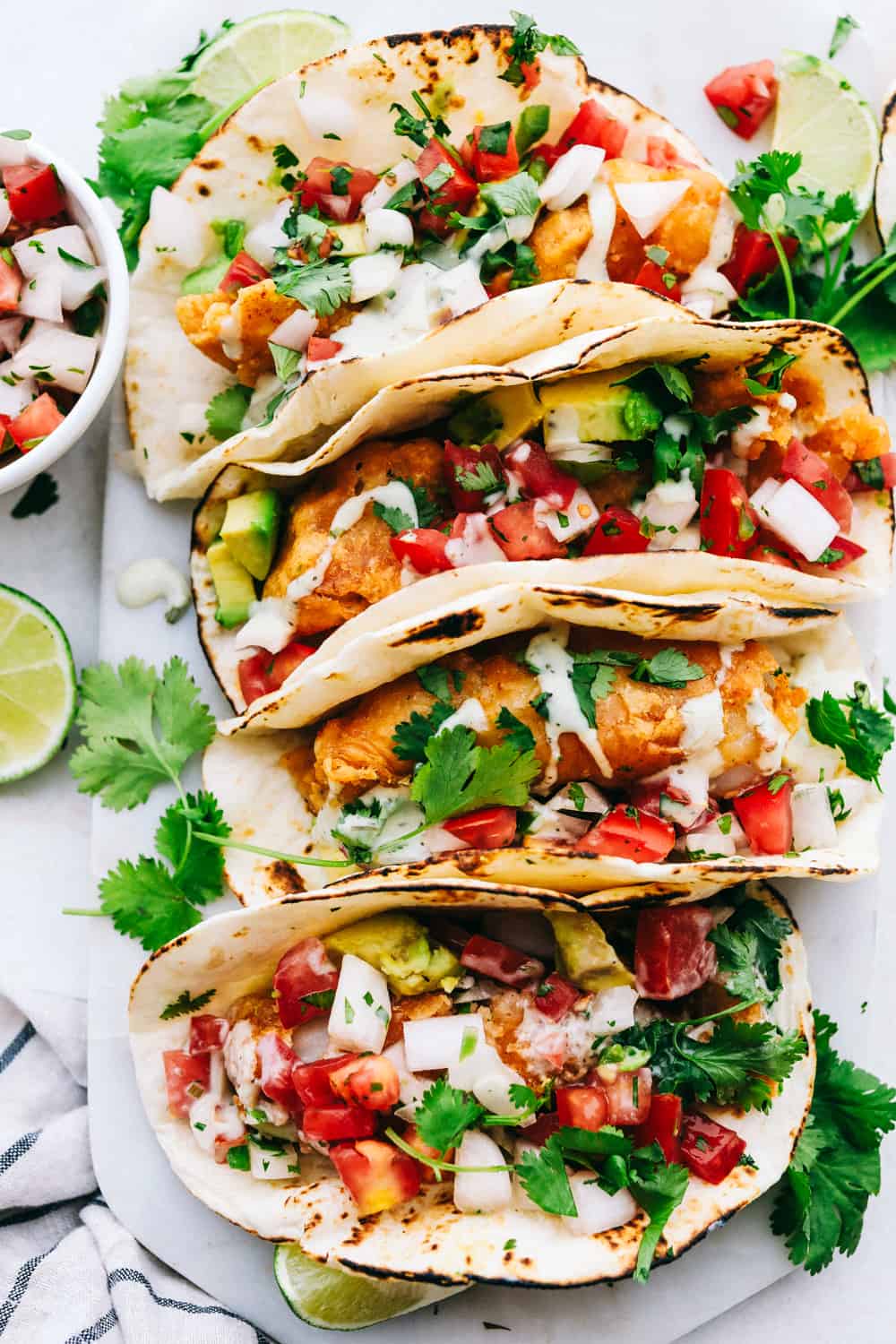 Baja fish tacos lined in a row.