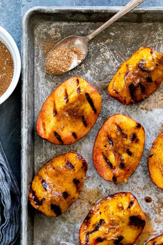 grilled peaches on a sheet tray