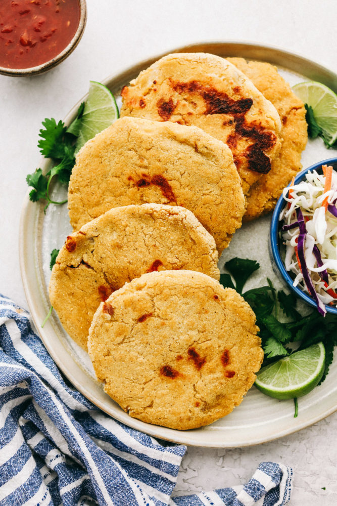 Easy Bean and Cheese Pupusas on a plate served with slaw and salsa.