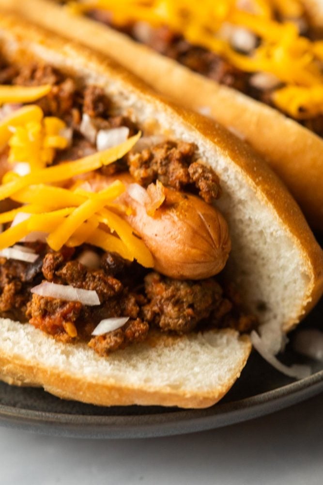 Super closeup of chili dogs on a plate