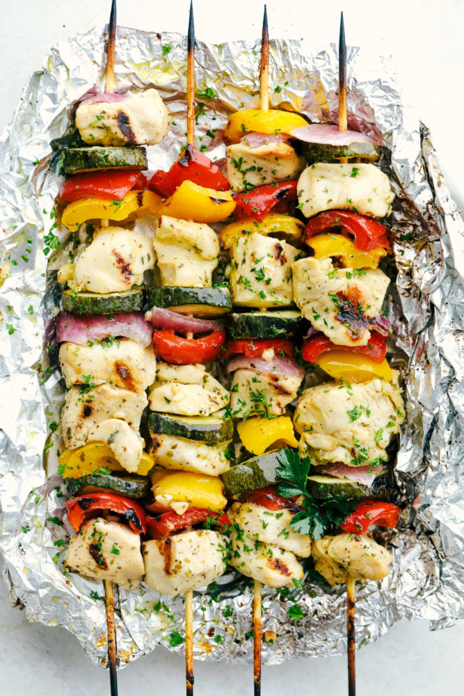 Chicken skewers wrapped in foil. 