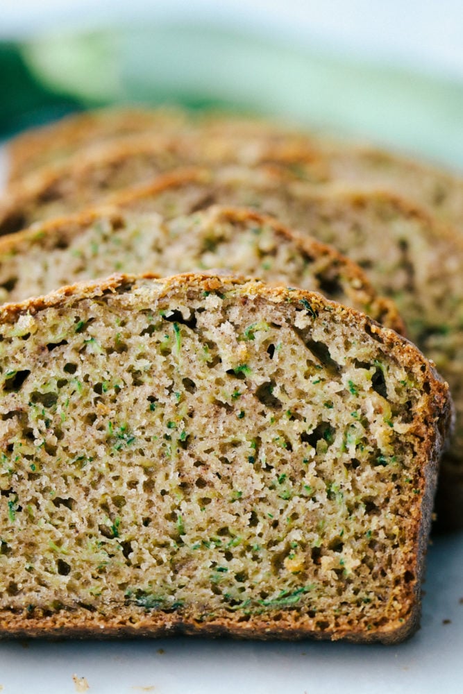 Photo facing the zucchini bread sliced and laying back. 