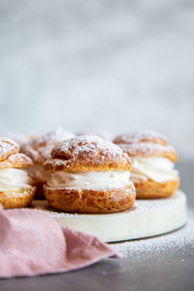 Cream puffs dusted with powdered sugar