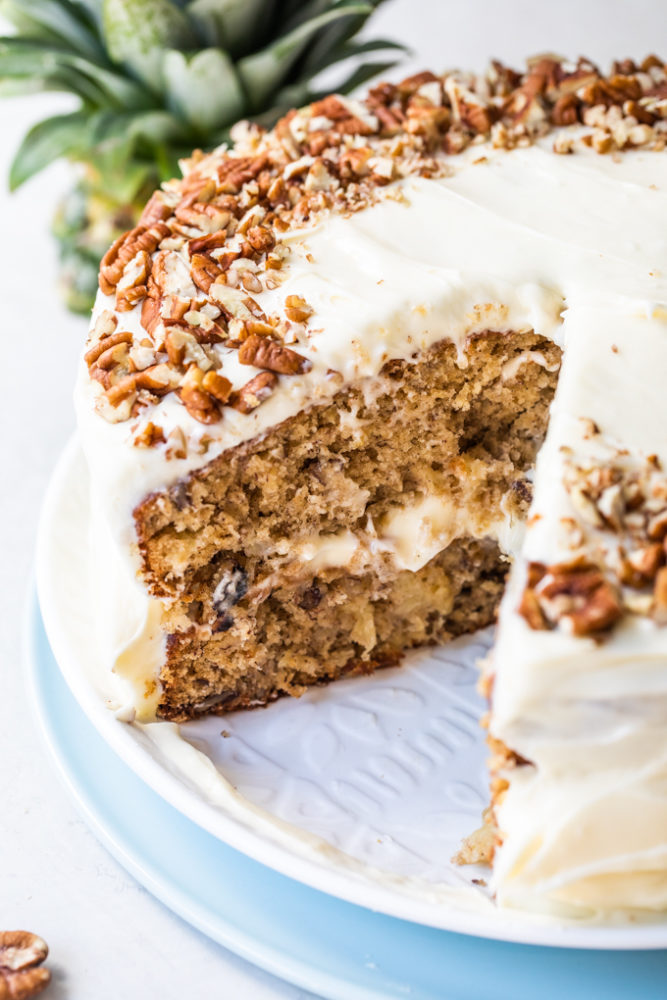 Hummingbird cake with a slice of cake taken out of it. 