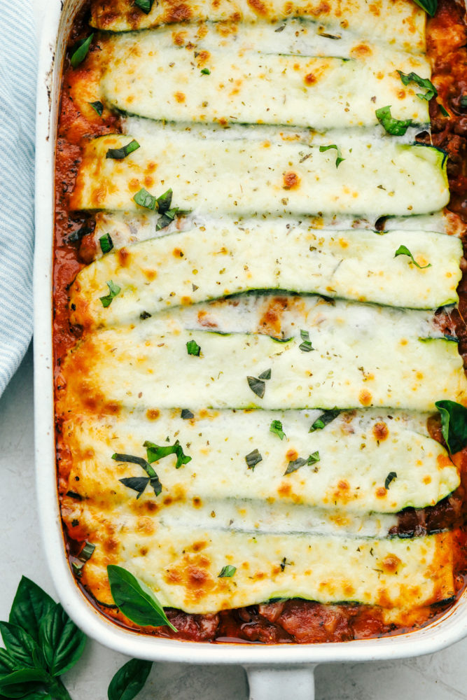 Zucchini lasagna in a white casserole dish. 