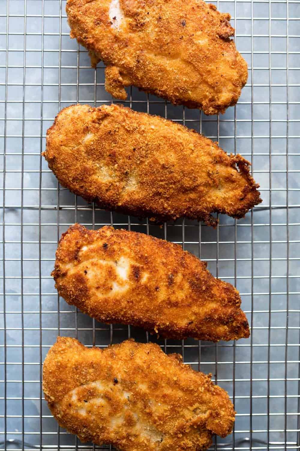 Fried chicken breasts on a wire rack