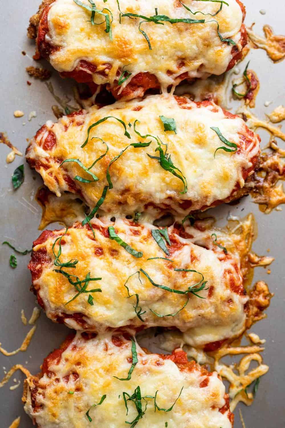 Chicken Parmesan baked and straight out of the oven on a baking tray