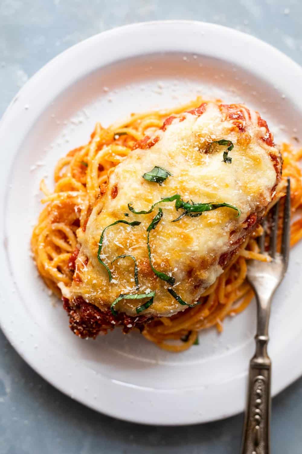 Chicken Parmesan served over spaghetti