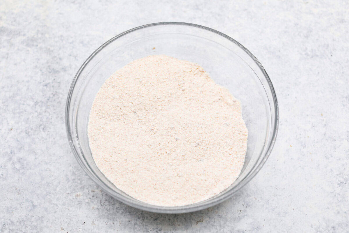 Overhead shot of the  flour, baking powder, baking soda, and salt mixed in a bowl.