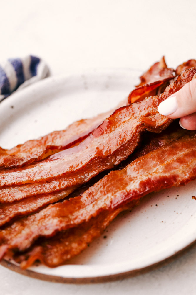 Perfectly Baked Crispy Bacon on a white plate.