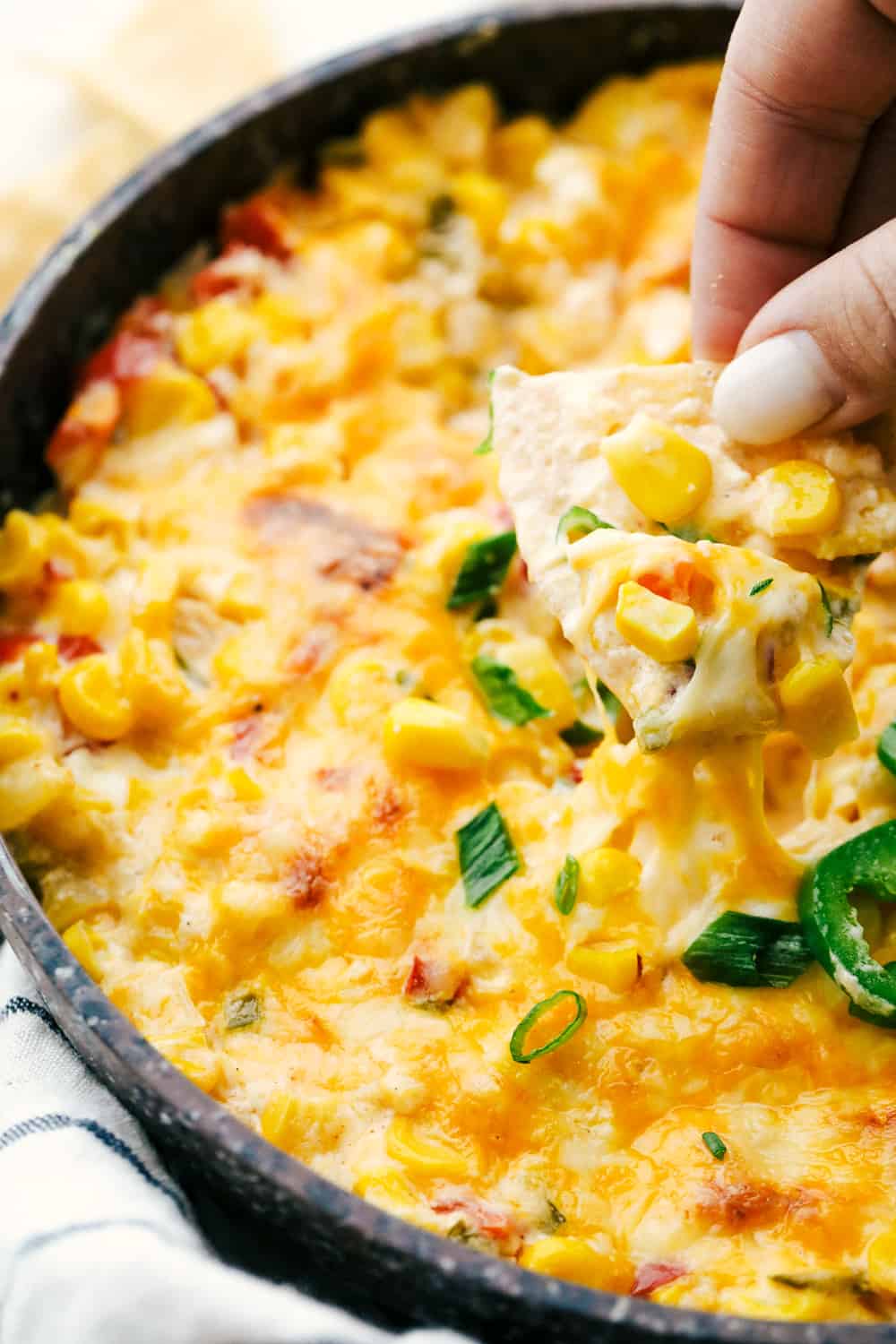 Hot Corn Dip with onions, peppers, jalapeno and ooey gooey cheese, served with corn chips.