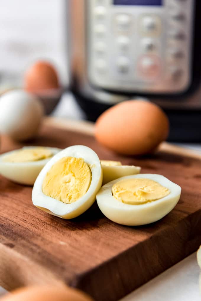 Sliced hard boiled eggs in front of an Instant Pot.