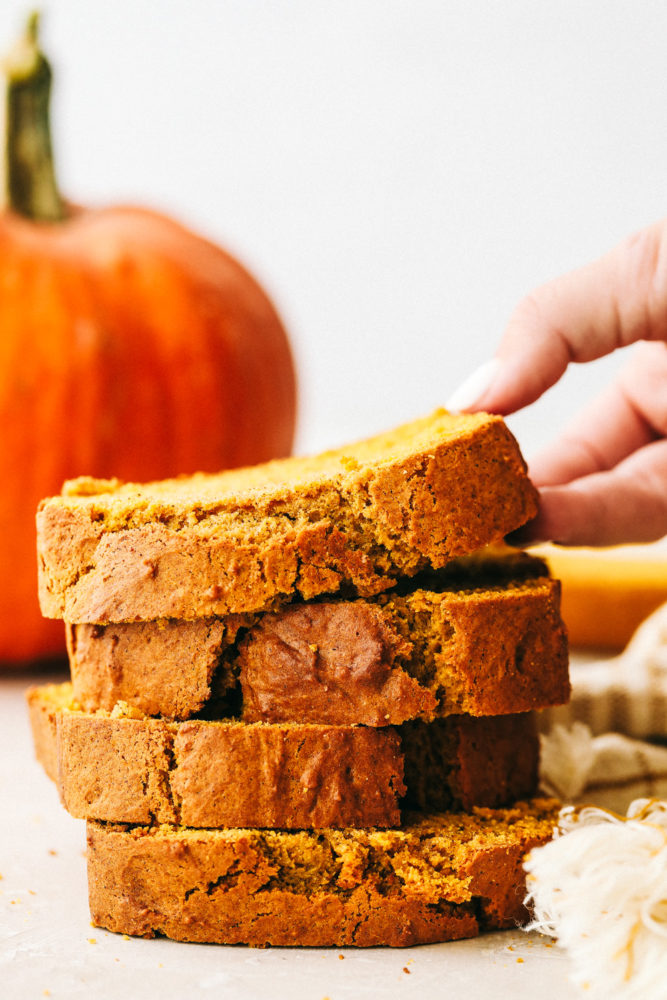 Perfectly spiced moist and tender pumpkin bread stacked on top of each other. 