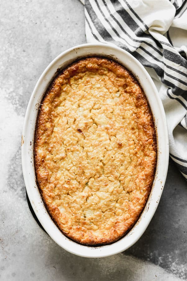 Corn pudding in a white dish. 