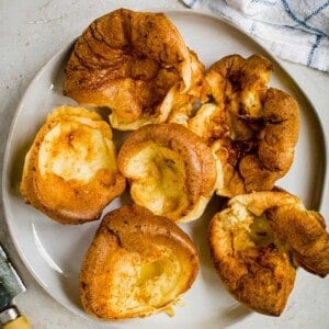 Individual Yorkshire pudding on a white plate.