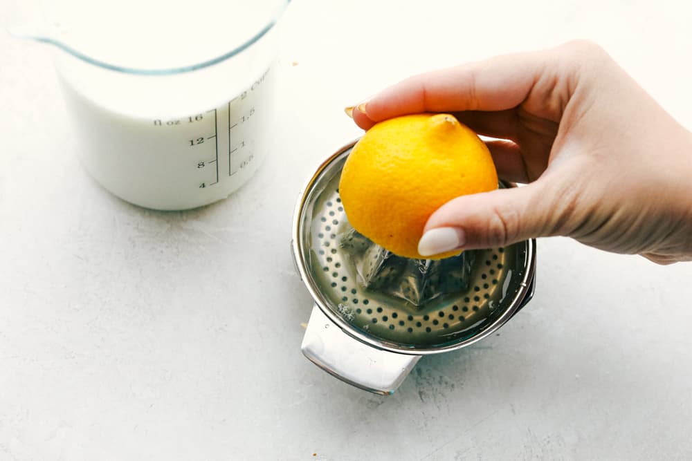 Squeezing lemon juice for homemade buttermilk. 