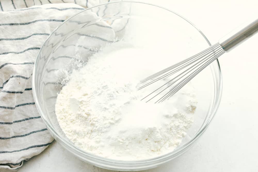 Mixing pancake mix ingredients in a bowl.