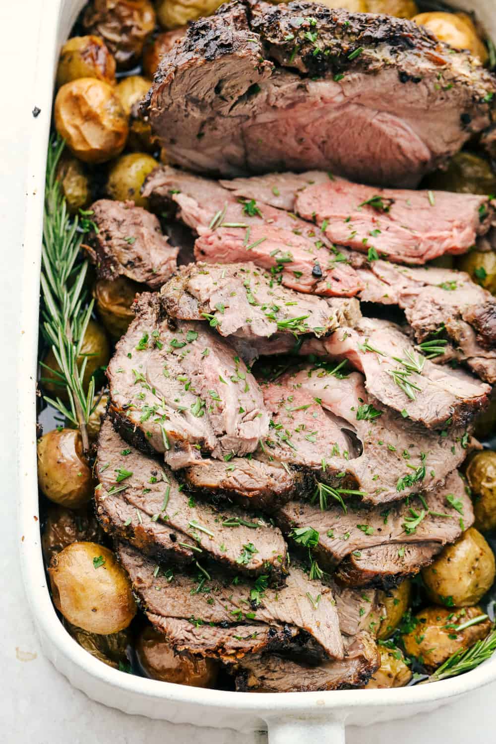 Succulent and savory Garlic Herb Crusted Lamb with potatoes.