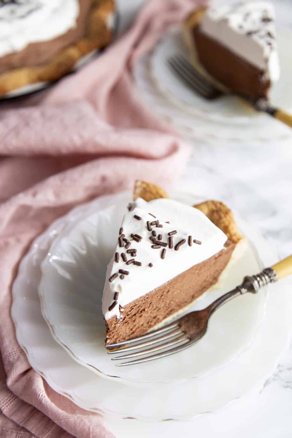 Slice of french silk pie on a plate.