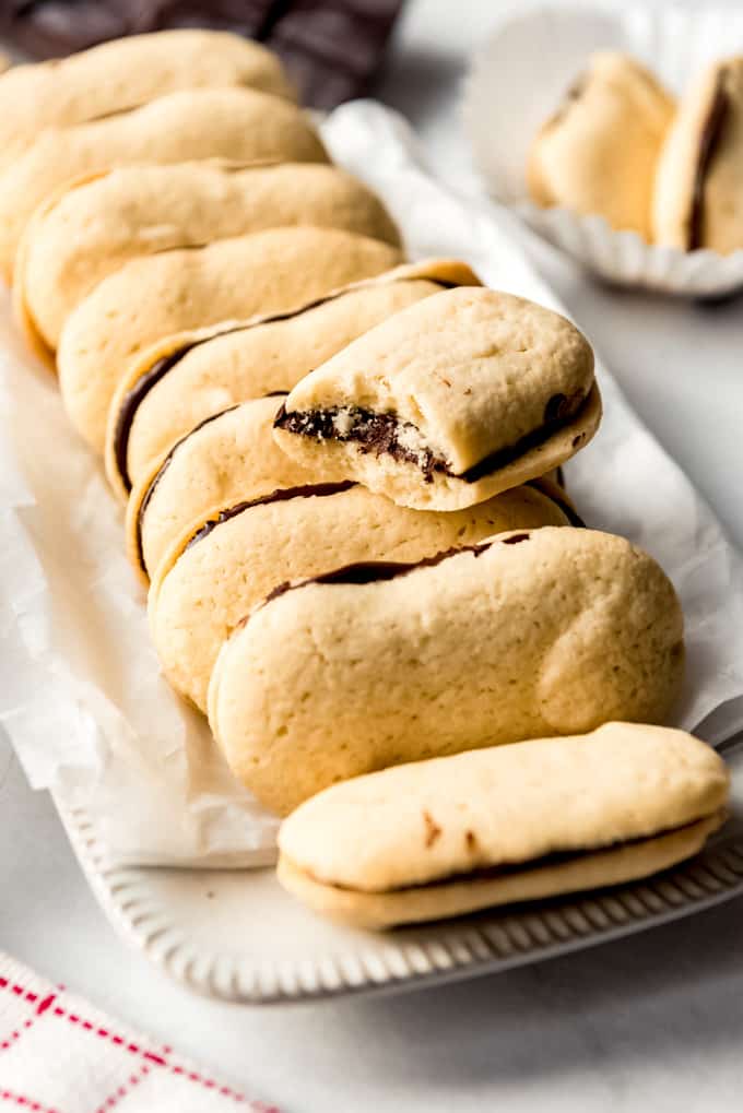 Milano cookies staked together on a white dish. 