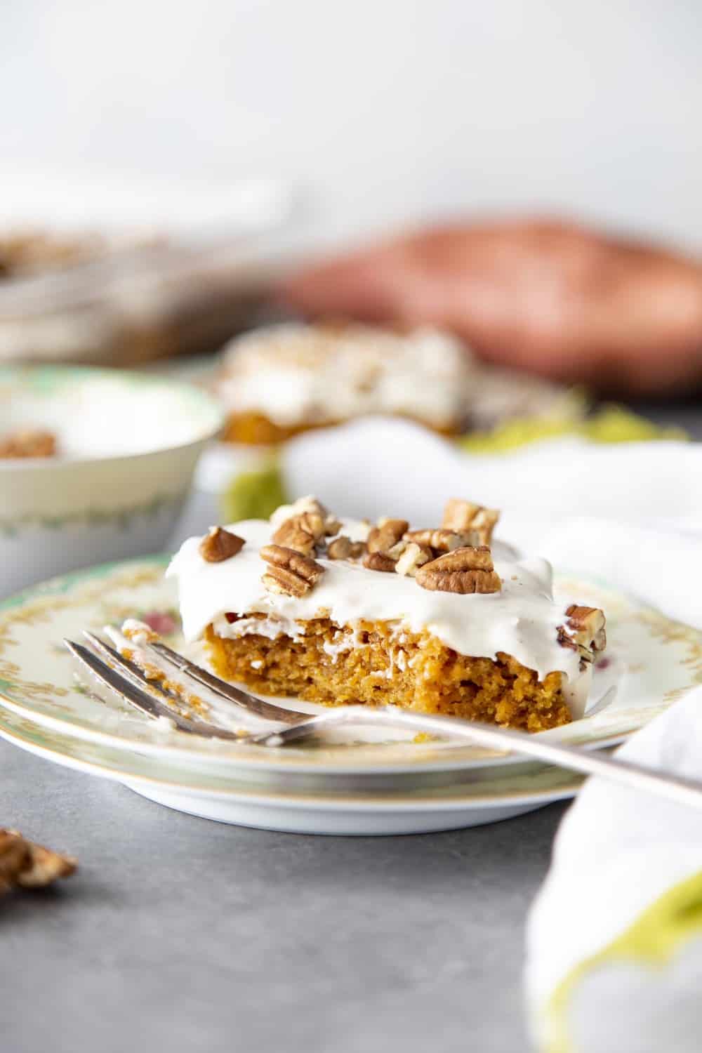 Sweet potato cake on a plate with a fork. 