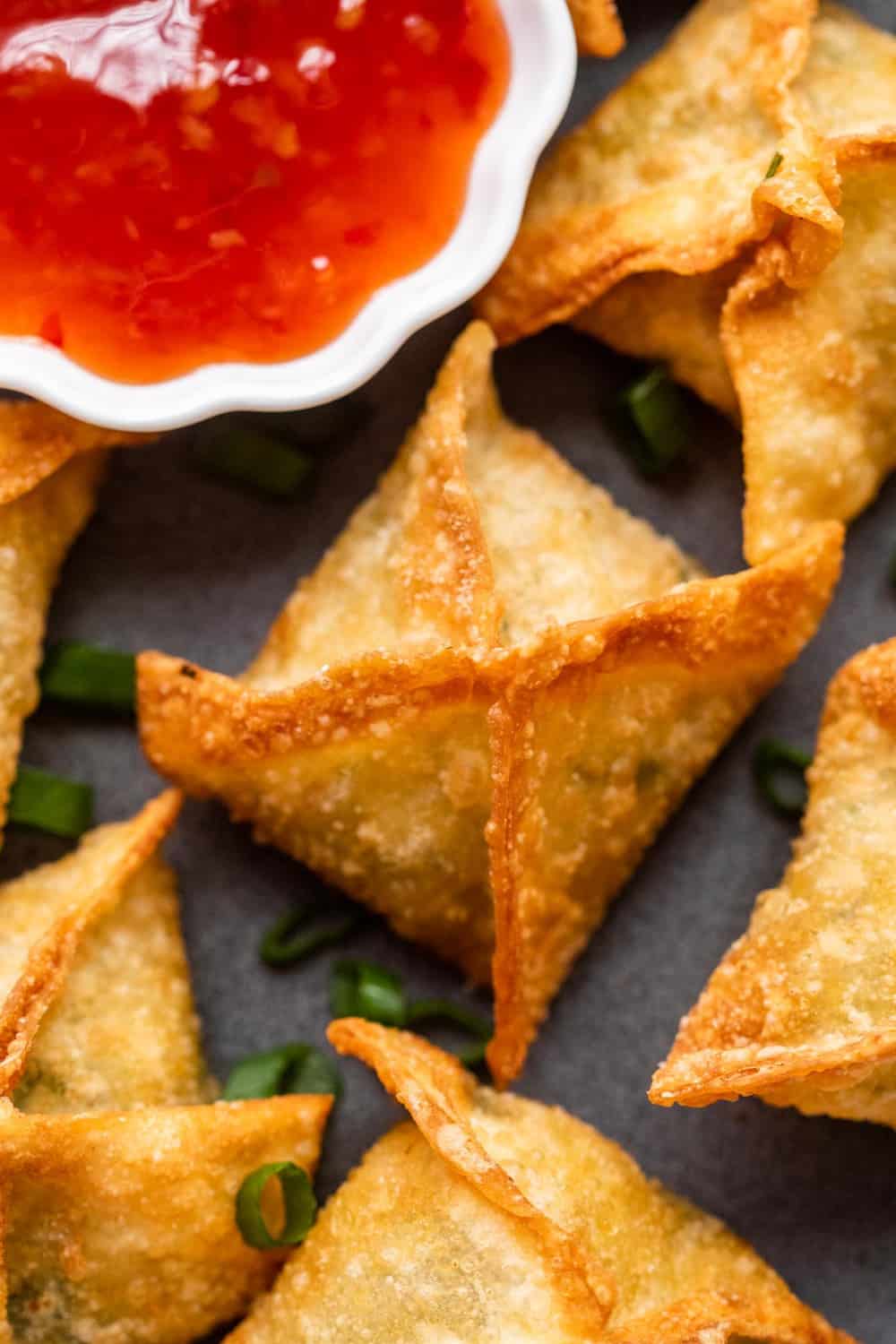 Closeup of a piece of crab rangoon on a plate