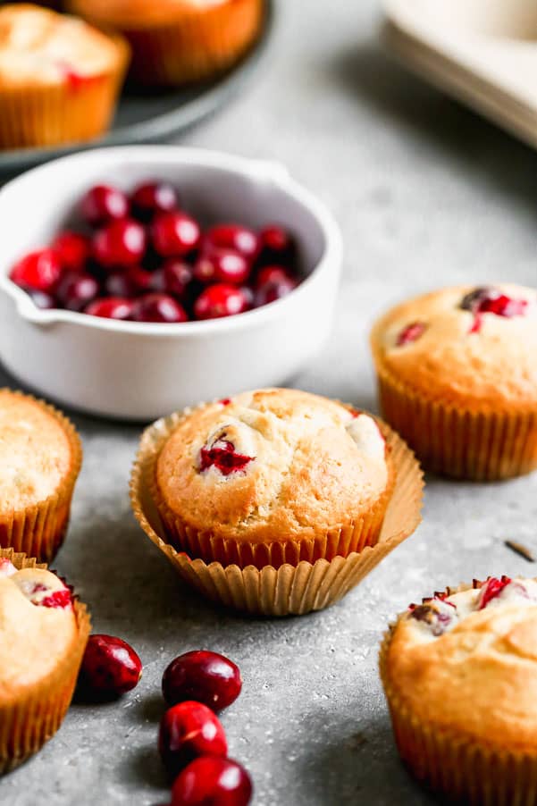 Cranberry muffins with cranberries in a bowl. 