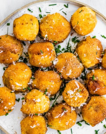 Mashed potato balls on a white plate.