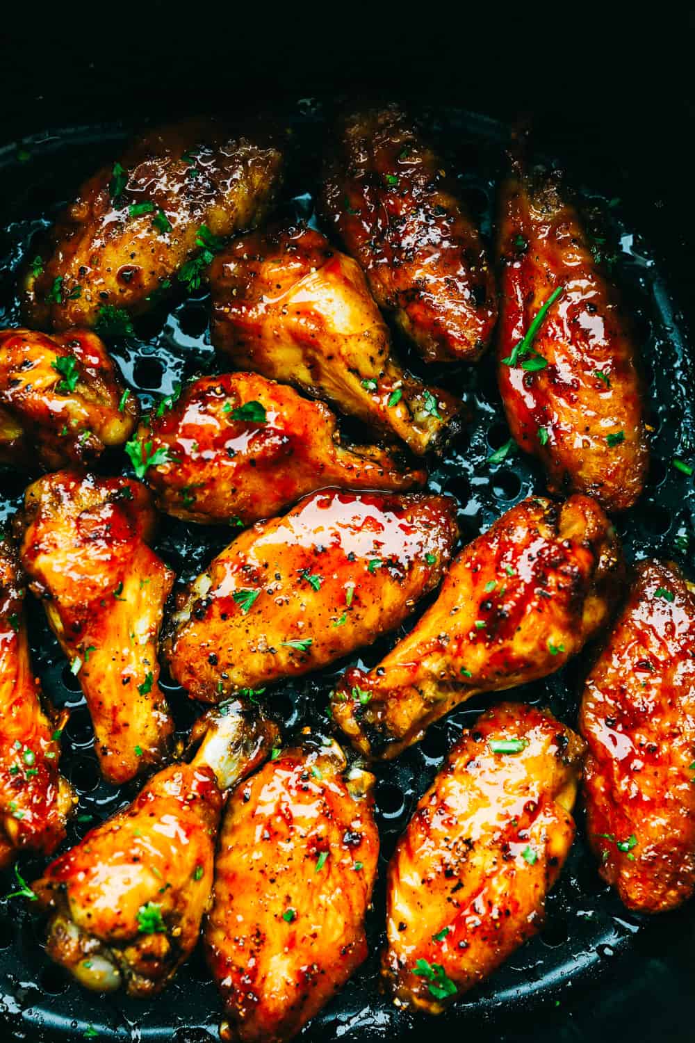 Spicy and crispy air fryer chicken wings with sauce.