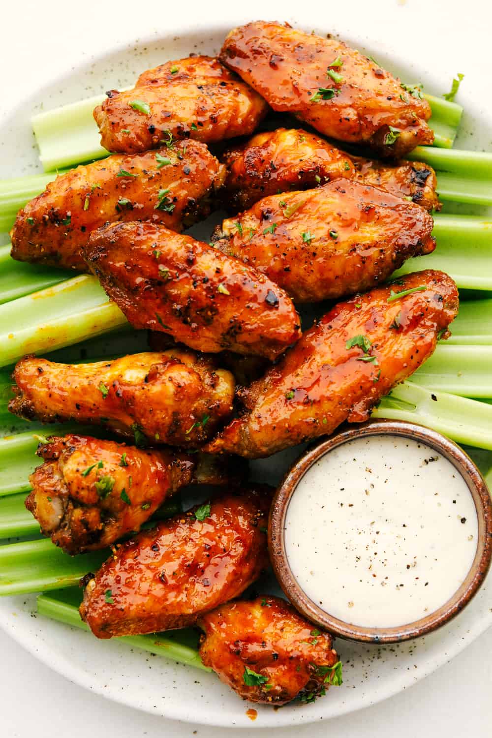 Crispy air fryer chicken wings with celery and dip.