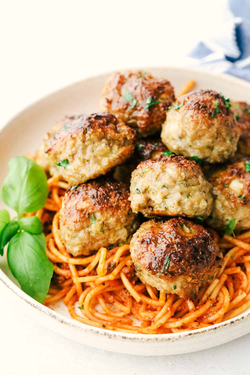 Perfectly baked turkey meatballs with spaghetti noodles and sauce. 