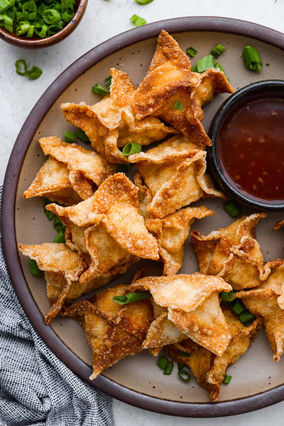 Overhead shot of crab rangoon on a serving platter. 